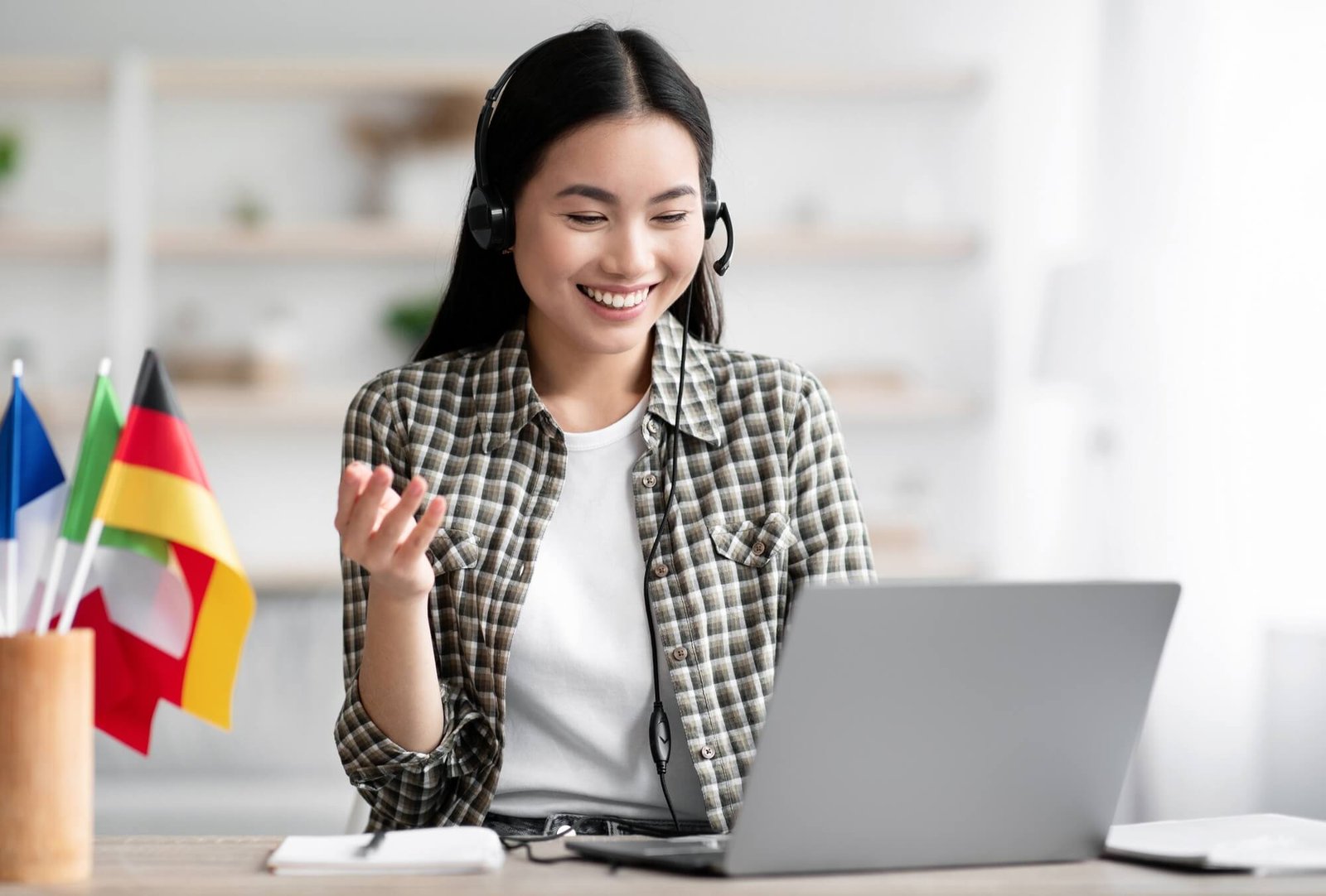 happy-asian-lady-using-laptop-and-headset-learning-foreign-language.jpg